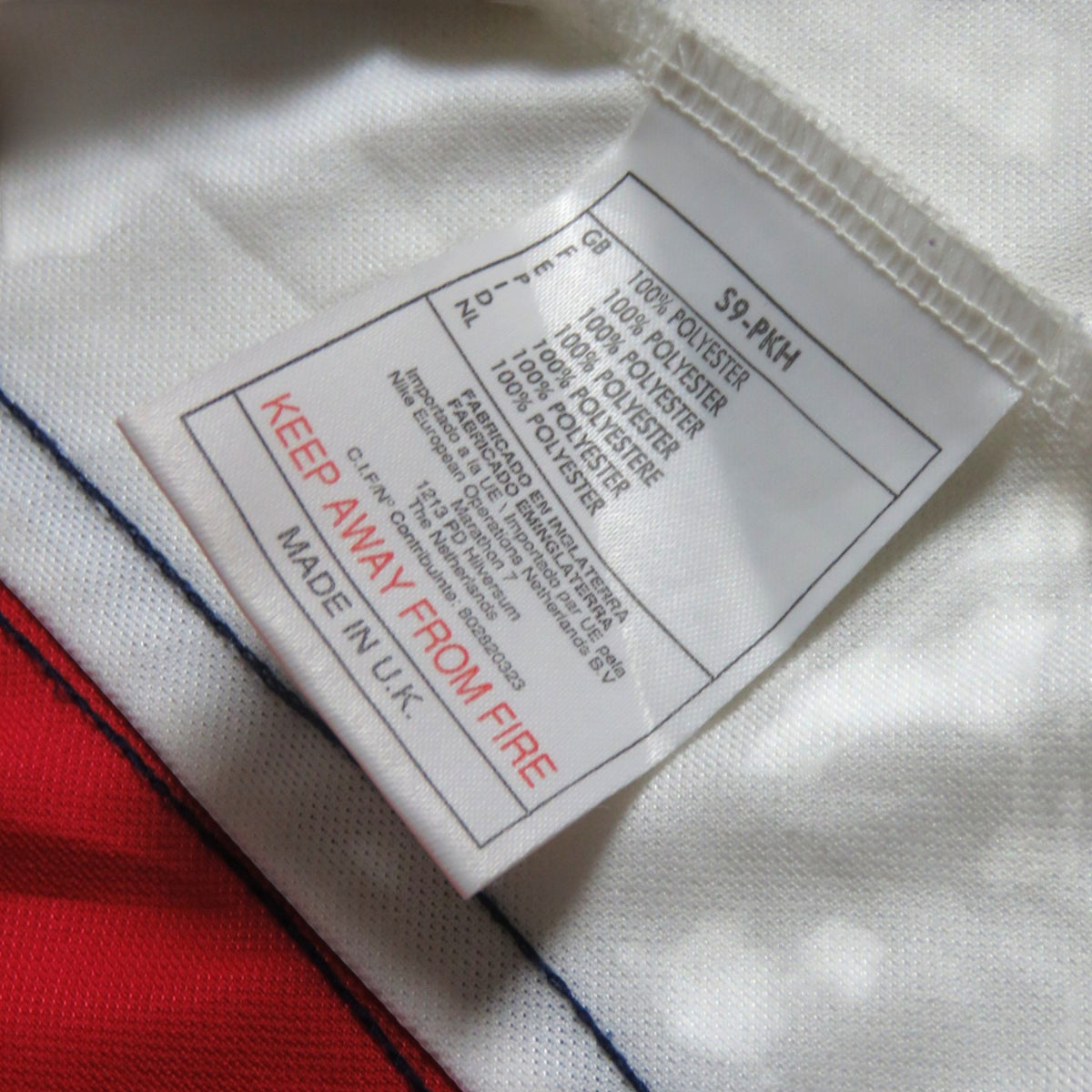 Nostalgic Football Shirts label van Arsenal 1998-99 thuisshirt met 100% polyester samenstelling en Made in UK tekst.