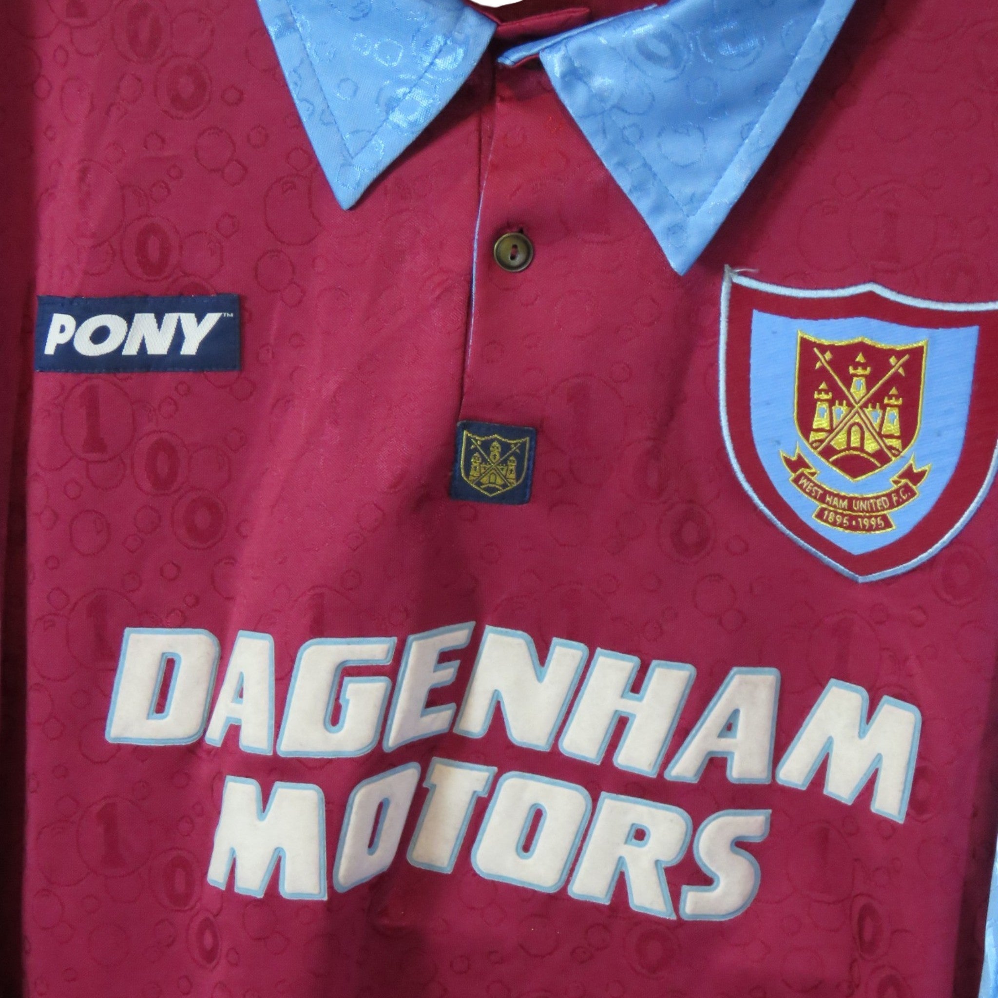 Nostalgic Football Shirts West Ham United 1995-97 home shirt in claret with sky blue collar and Dagenham Motors logo.